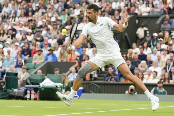 Novak Djokovic wins his first match at Wimbledon with a sleeve on his  surgically repaired knee | AP News