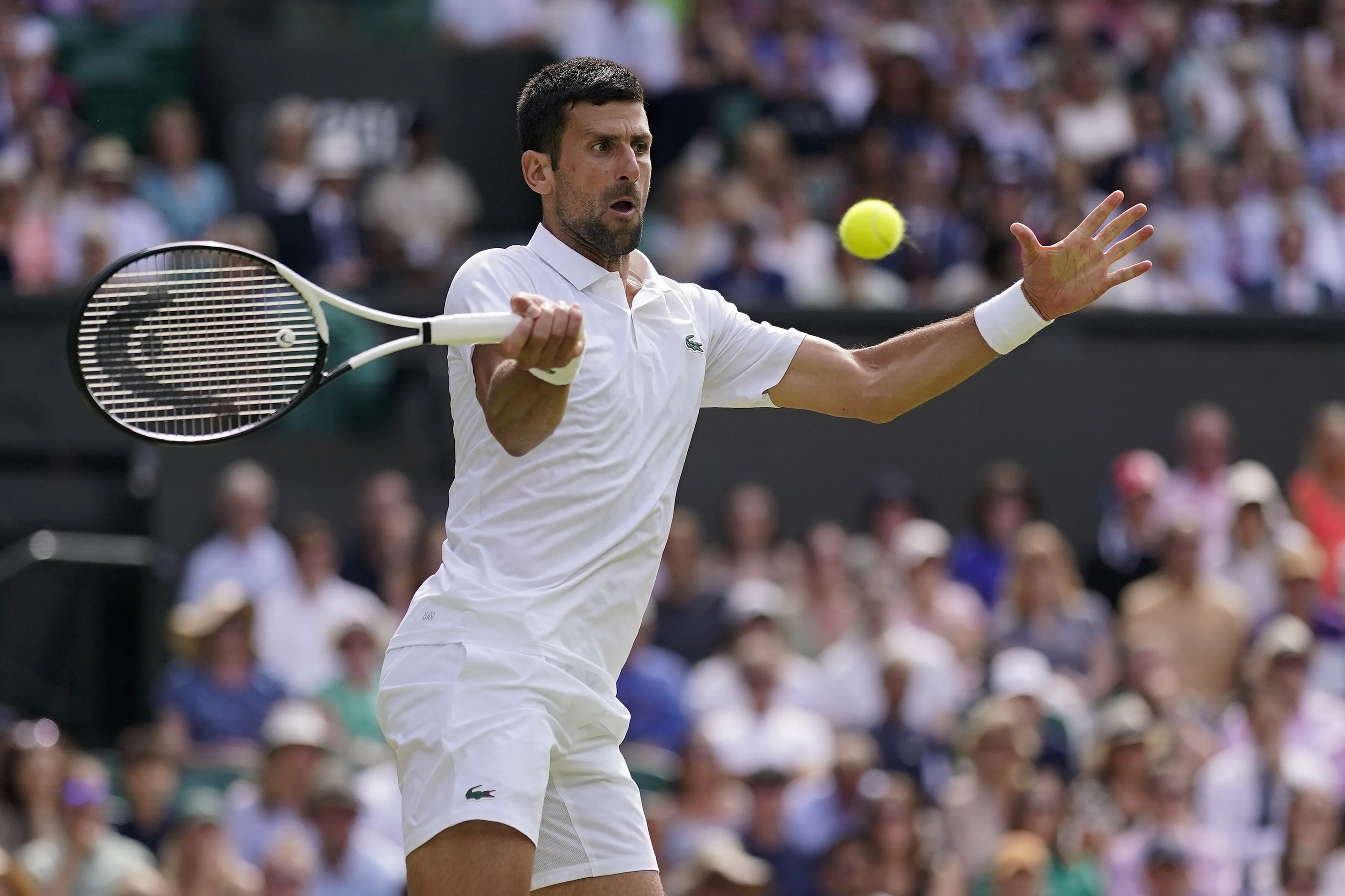 Novak Djokovic plays at Wimbledon with the number '23' printed on his white  tennis shoes - Rocky Mountain News