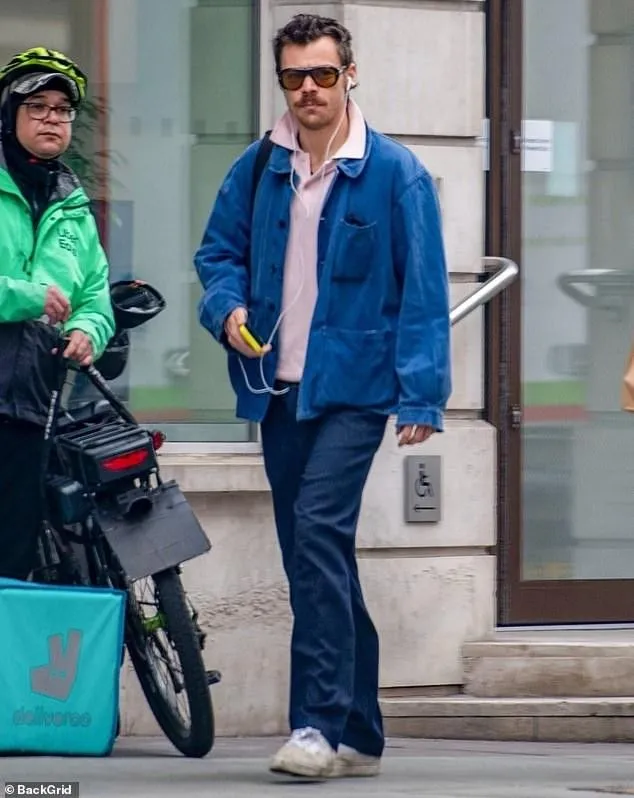 Harry Styles listens to music with wired headphones, amid speculation about  his fourth album - Telegraph