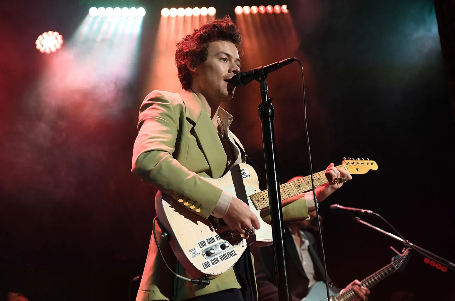 Harry Styles' Guitar, Bono's Lyrics & More Sold at Auction for Charity